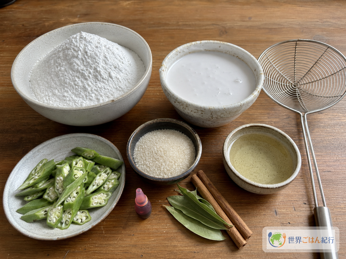 米粉、ココナッツミルク、オクラ、砂糖、油温計を並べたアースミの材料